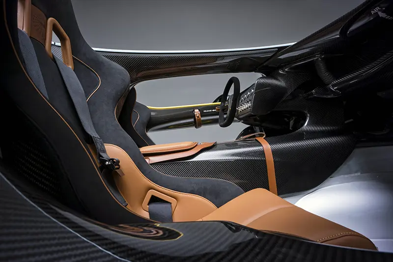 The CC100's seats are made with a light, black weave, 
mixed with Aston Martin’s trademark hand-crafted tan leather
