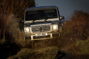 Mercedes G-Class driving through a forest terrain