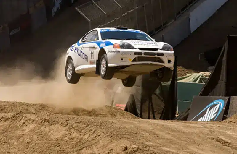 A 2005 Hyundai Coupe Tiburon in a rally car jumping competition