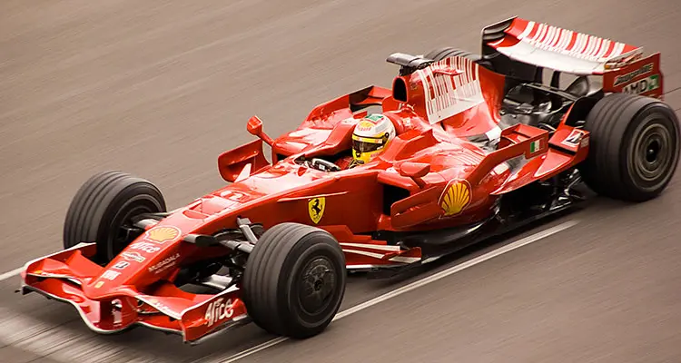 Red Ferrari F1 race car on track