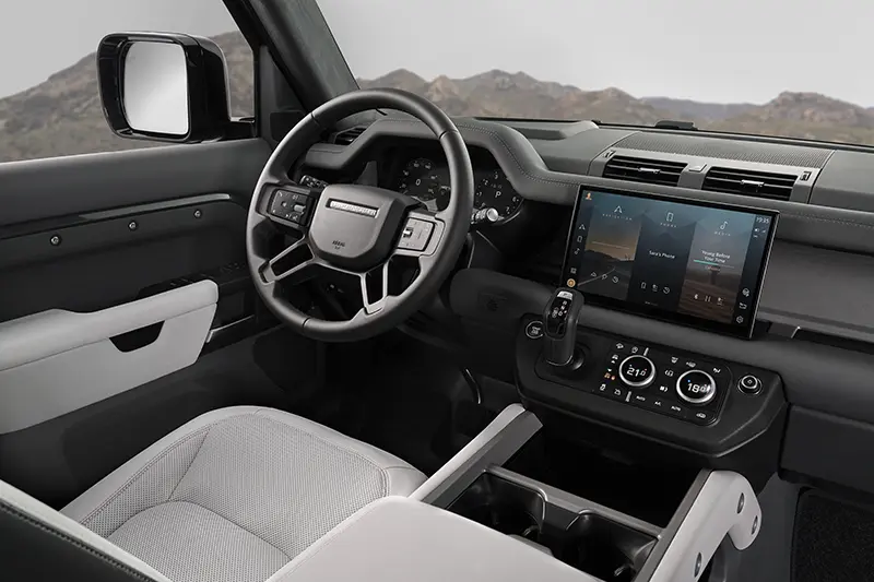 Land Rover Defender 130 V8 interior showcasing infotainment screen and modern center console