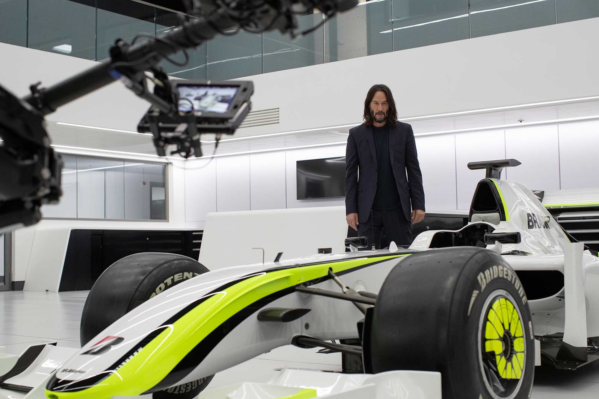Keanu Reeves on the set of Brawn: The Impossible Formula 1 Story