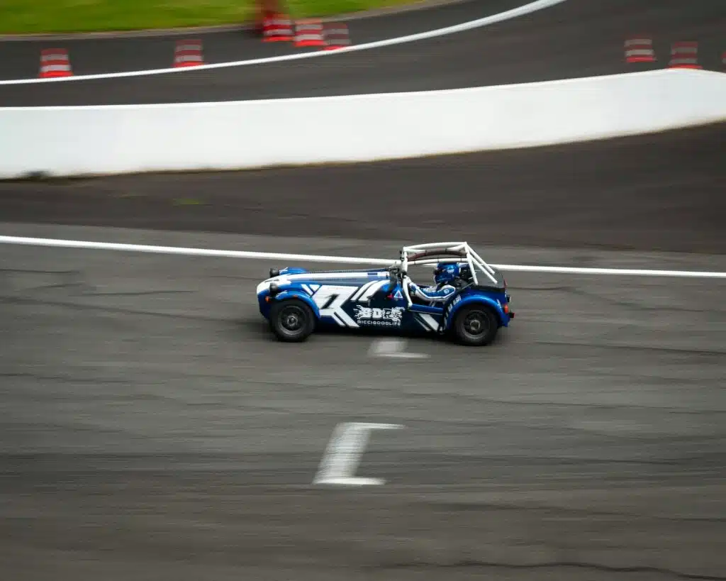 blue and black racing car on Caterham track field