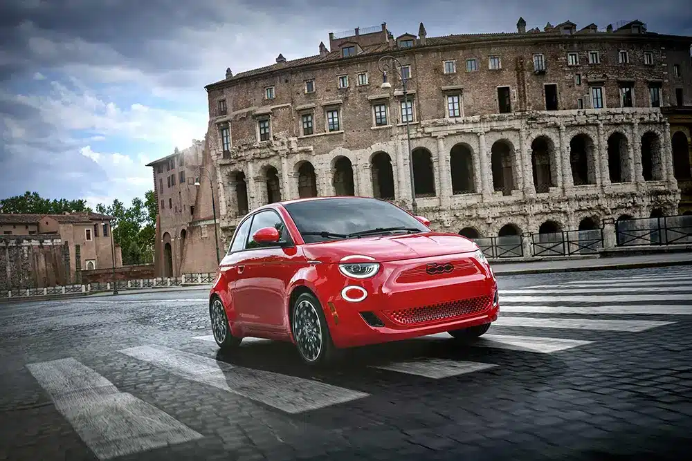 Red Fiat 500e ev at the colosseum in Rome