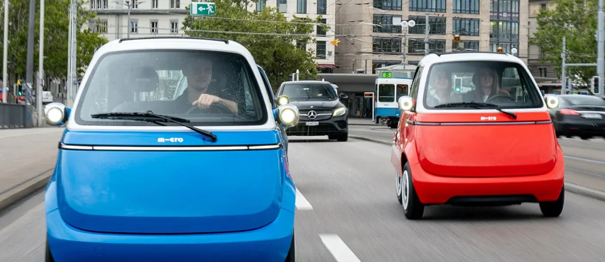 Microlino small electric cars on dual carriageway