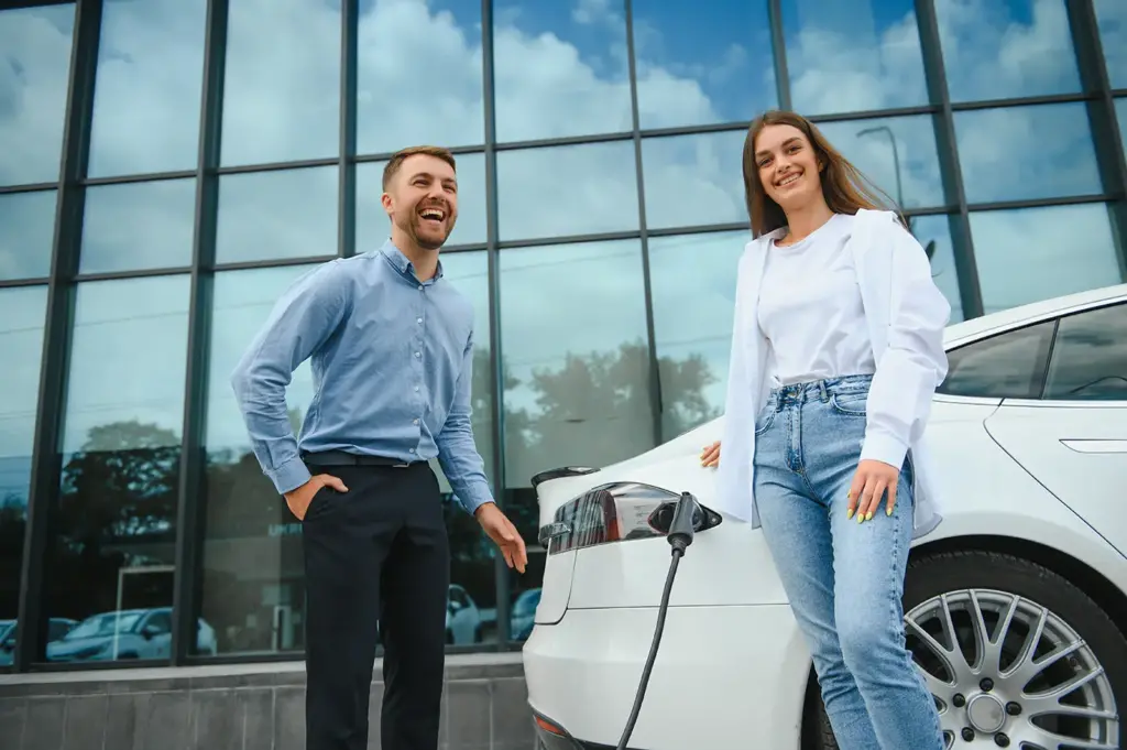 couple at a public electric car charging station