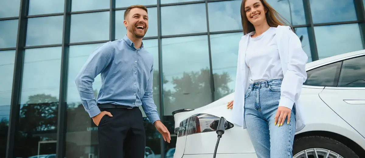 couple at a public electric car charging station