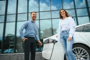 couple at a public electric car charging station