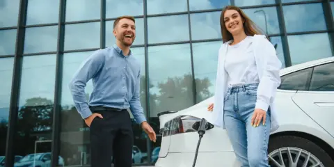 couple at a public electric car charging station