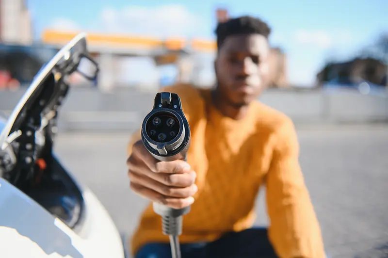 Man charging his electric car