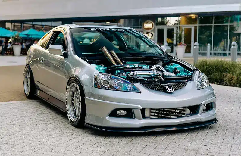 Honda Civic ricer with custom bonnet showing a modified high performance engine