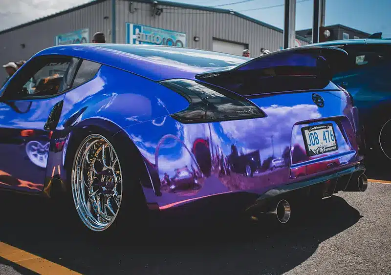 bold mods and unique styling, a two-tone customized Nissan 370Z seen at a ricer meet event.