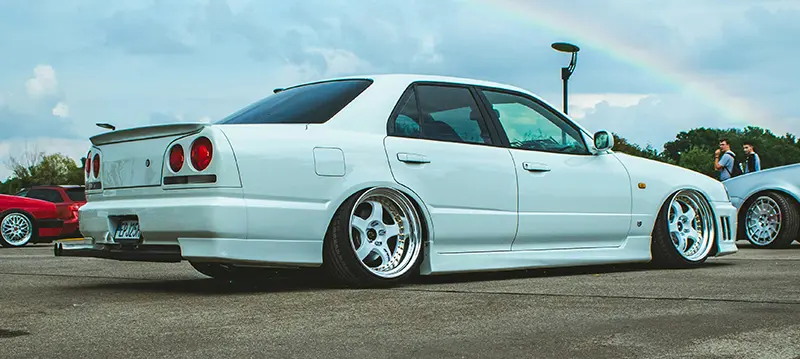 Ricer car at a roadshow with outward slanting wheels