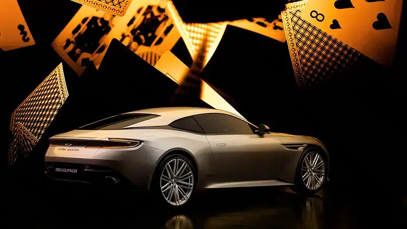 Rear side view of Aston Martin DB12 Goldfinger Edition with distinctive taillights.