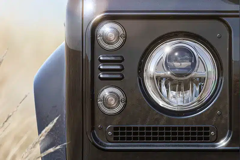 Close-up view of the Custom Retro Classic Defender V8's LED headlights, merging classic styling with modern technology.