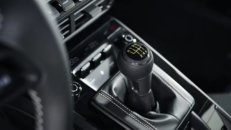 Interior view of the 2024 Porsche 911 GT, focusing on the gear stick and center console.