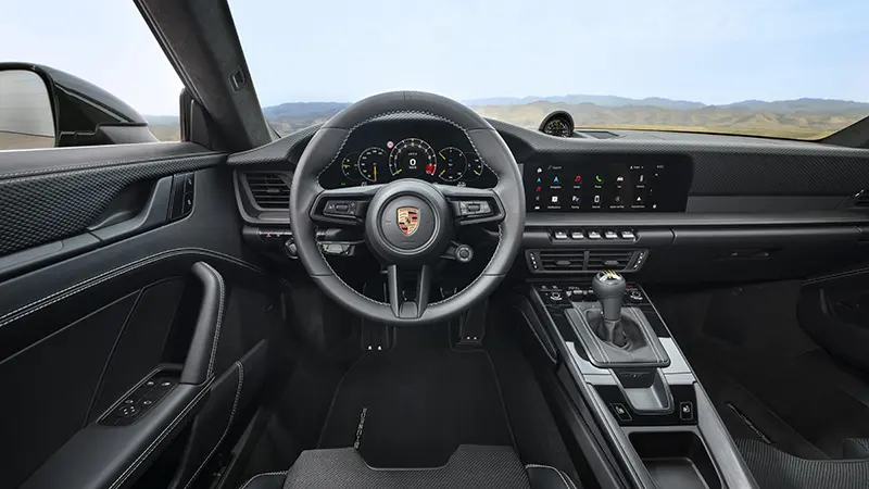 Inside view of the 2024 Porsche 911 GT3 with Touring Package, highlighting luxury and sporty design.