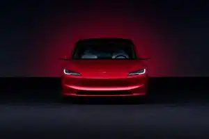 Tesla Model 3 Long Range in Ultra Red showcasing sleek design and electric performance