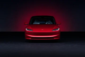 Tesla Model 3 Long Range in Ultra Red showcasing sleek design and electric performance