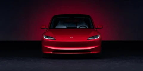 Tesla Model 3 Long Range in Ultra Red showcasing sleek design and electric performance