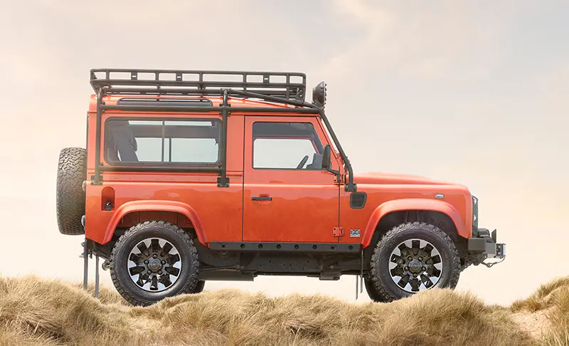 Side view of the Custom Retro Classic Defender V8, featuring Sawtooth alloy wheels and a rugged stance, ready for off-road challenges.