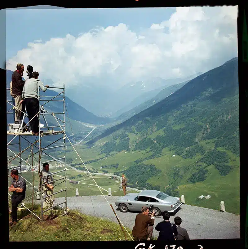 Celluloid film frame from Goldfinger, showing Sean Connery with Aston Martin DB5 in Swiss mountains, included with each purchase of the Aston Martin DB12 Goldfinger Edition