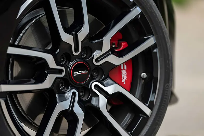 Close-up of the alloy wheels on the Mini JCW, featuring a bold and intricate design.