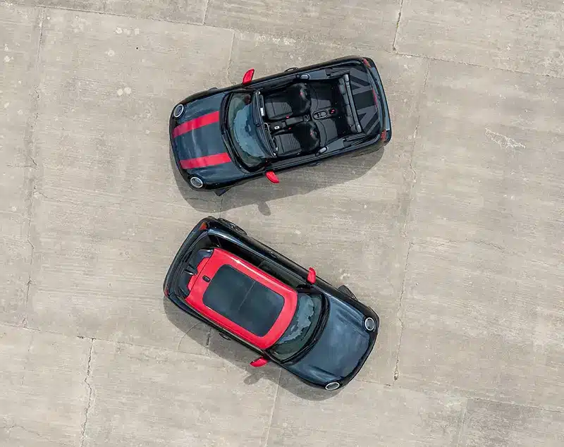 Birdseye view of the Mini JCW Hatchback and Cabriolet parked side by side.