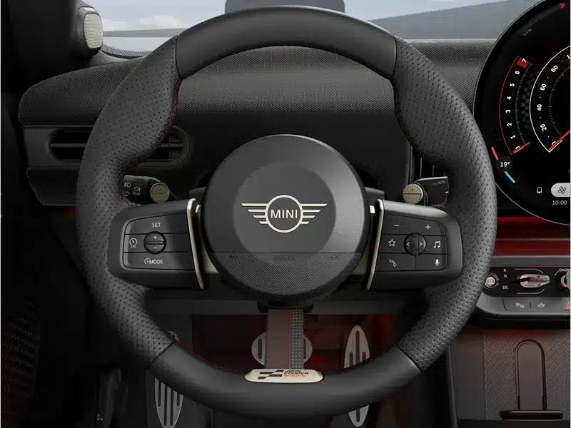 Close-up of the Mini John Cooper Works steering wheel with JCW branding and sporty detailing.