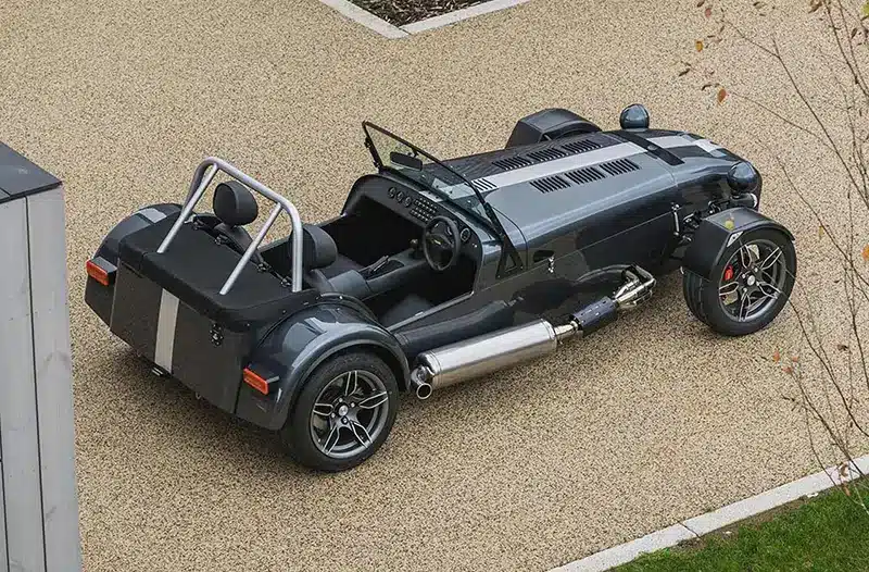 Bird’s eye view of the Caterham Seven CSR Twenty interior with a satin carbon dashboard and leather Momo steering wheel.