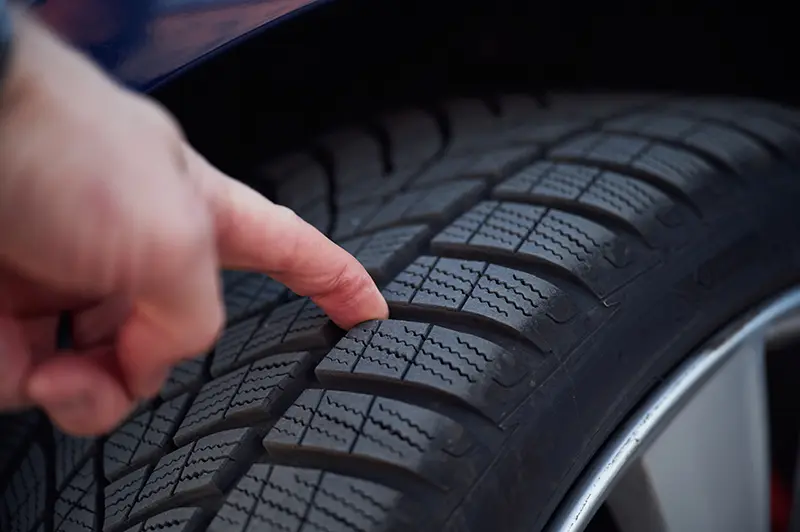 Checking the tread on your car tyre for safety in winter driving