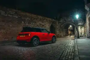 New MINI John Cooper Works hatchback parked on a village road.