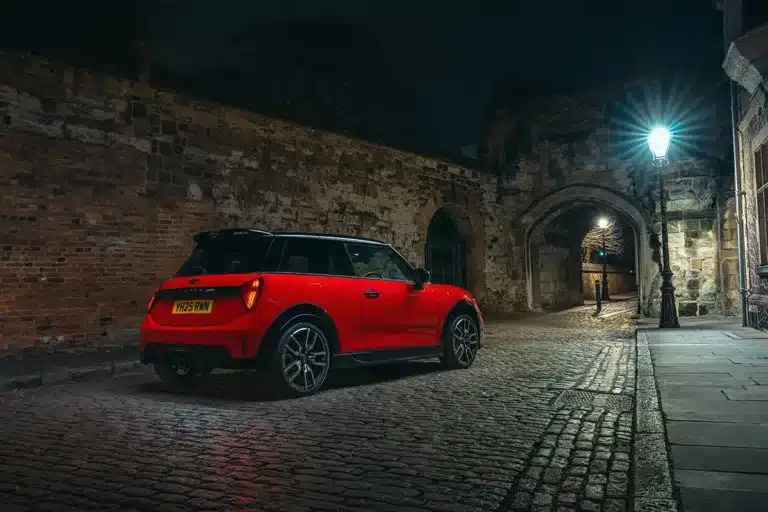 New MINI John Cooper Works hatchback parked on a village road.