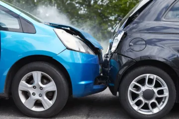 Close up view of two cars in a road traffic accident in the UK