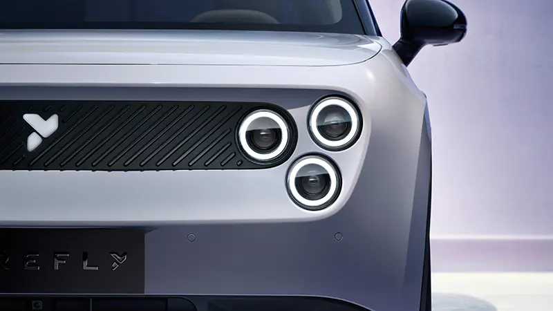 Close-up of Nio Firefly UK LED headlights and front grille logo