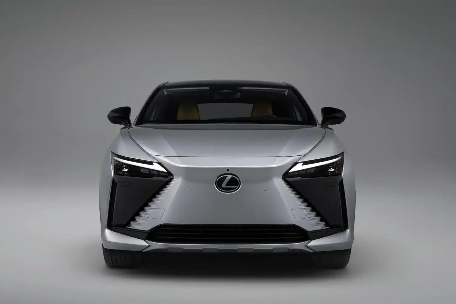 Front view of the Lexus RZ 600e F Sport Performance electric SUV in silver studio lighting