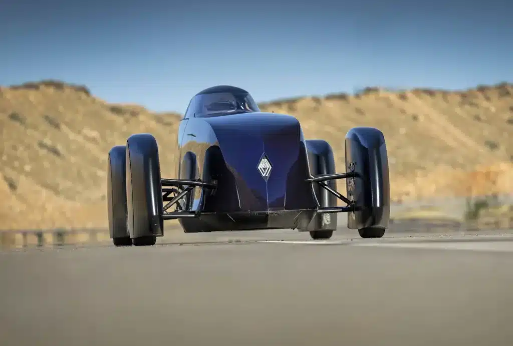 Renault Filante Record EV front view driving on open road, showcasing aircraft-inspired aerodynamic nose design