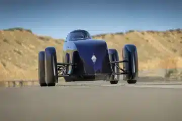 Renault Filante Record EV front view driving on open road, showcasing aircraft-inspired aerodynamic nose design