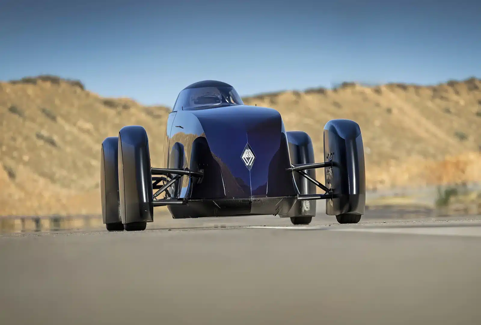 Renault Filante Record EV front view driving on open road, showcasing aircraft-inspired aerodynamic nose design