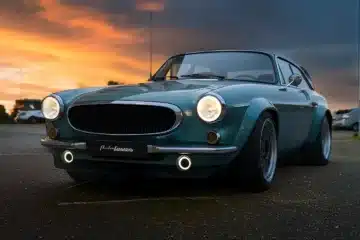 Autoforma Norrsken Volvo P1800 ES Restomod photographed from the front at sunset showing widened arches, LED lighting and classic Volvo styling