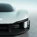 Front close-up of the Xiaomi Vision Gran Turismo concept car showing the MI logo, teardrop cockpit, and carbon fiber aerodynamic splitter.