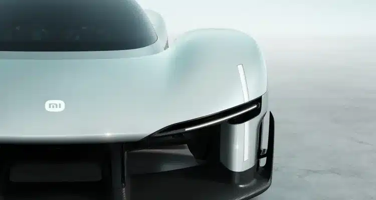 Front close-up of the Xiaomi Vision Gran Turismo concept car showing the MI logo, teardrop cockpit, and carbon fiber aerodynamic splitter.