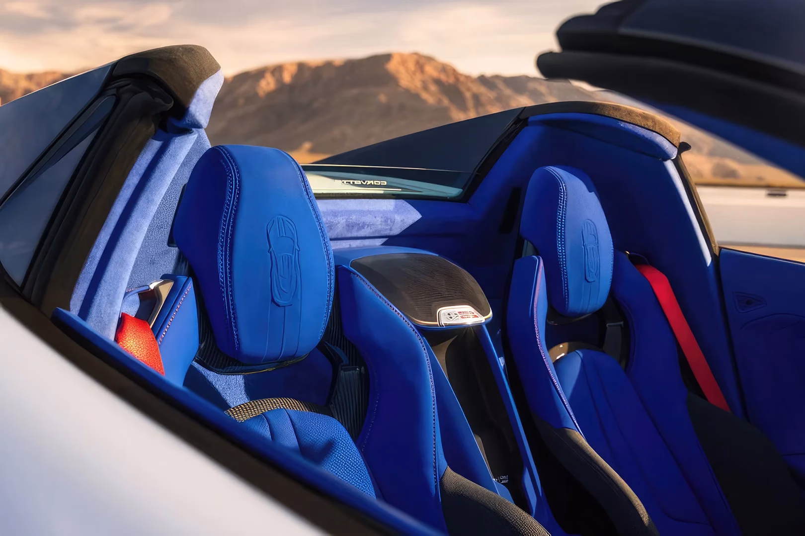 Santorini Blue seats inside a 2027 Chevrolet Corvette Grand Sport with red seat belts