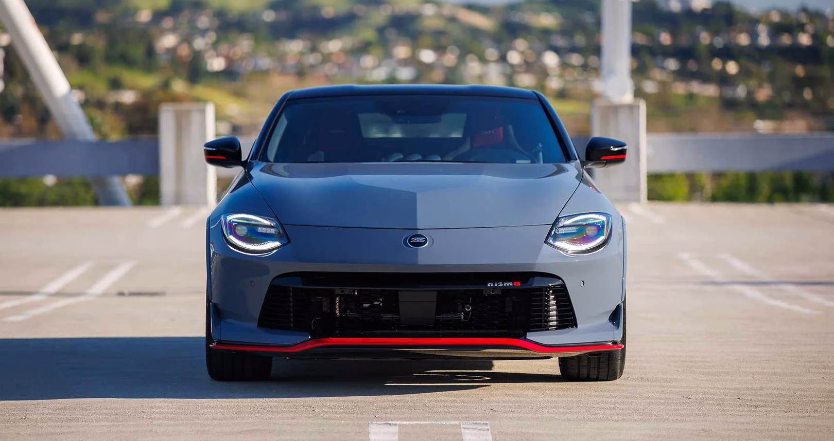 Head-on view of a grey Nissan Z NISMO with red front splitter trim