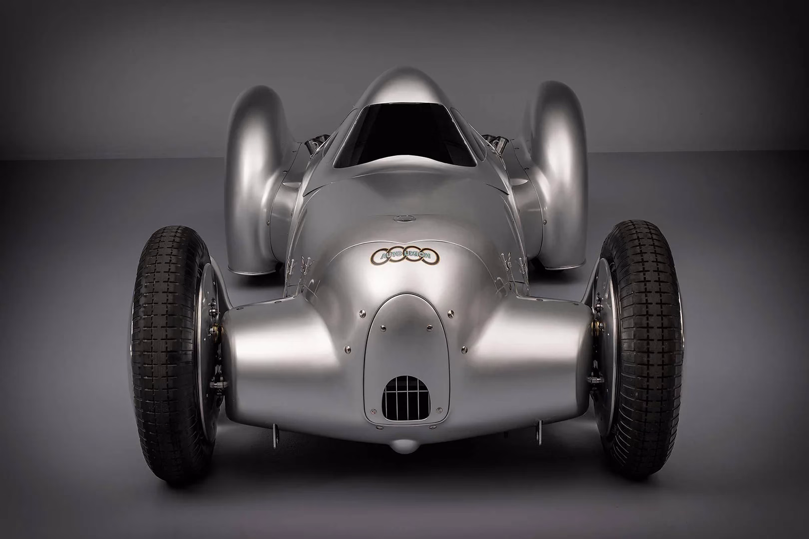Head-on studio view of the recreated Auto Union Lucca with exposed front tyres
