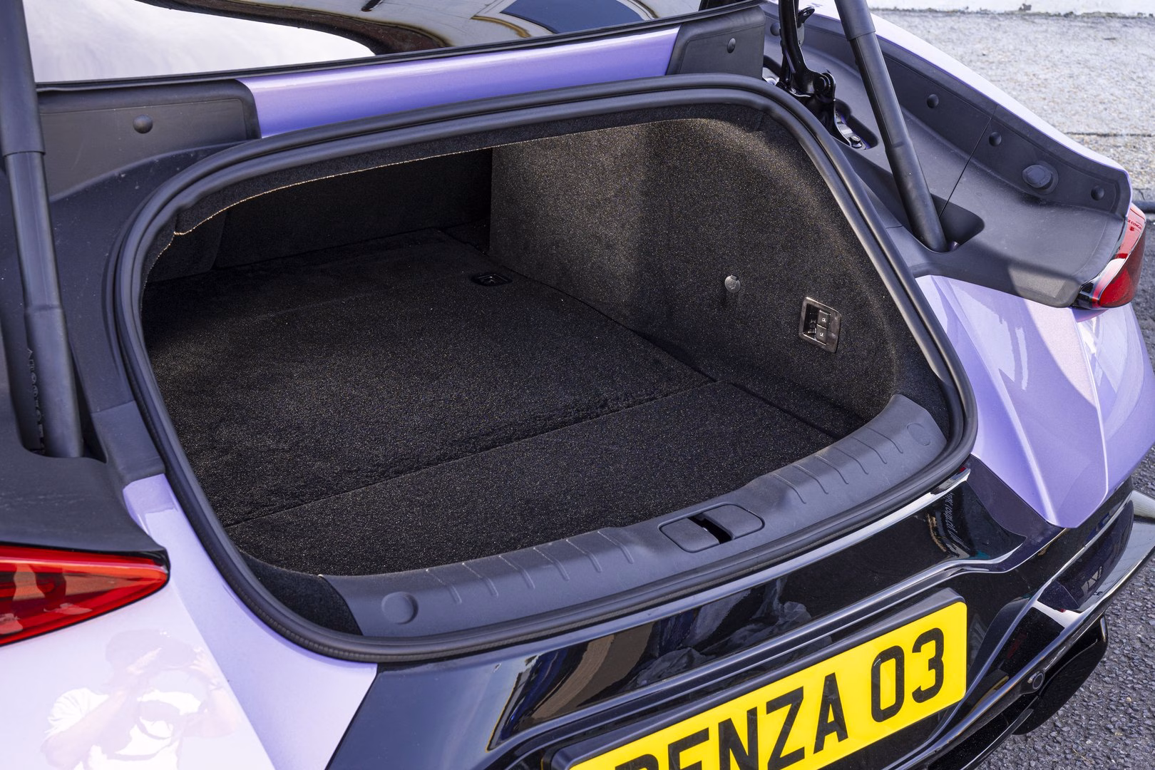 Open rear boot of a BYD Denza Z showing the carpeted luggage area