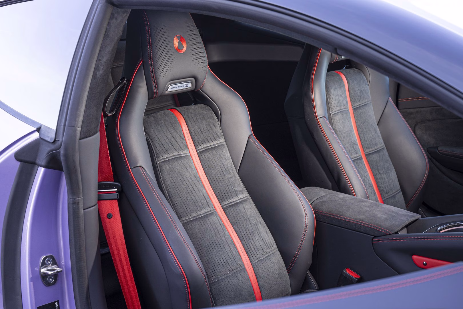 BYD Denza Z front sports seats in black suede and leather with red piping and Denza Z badging