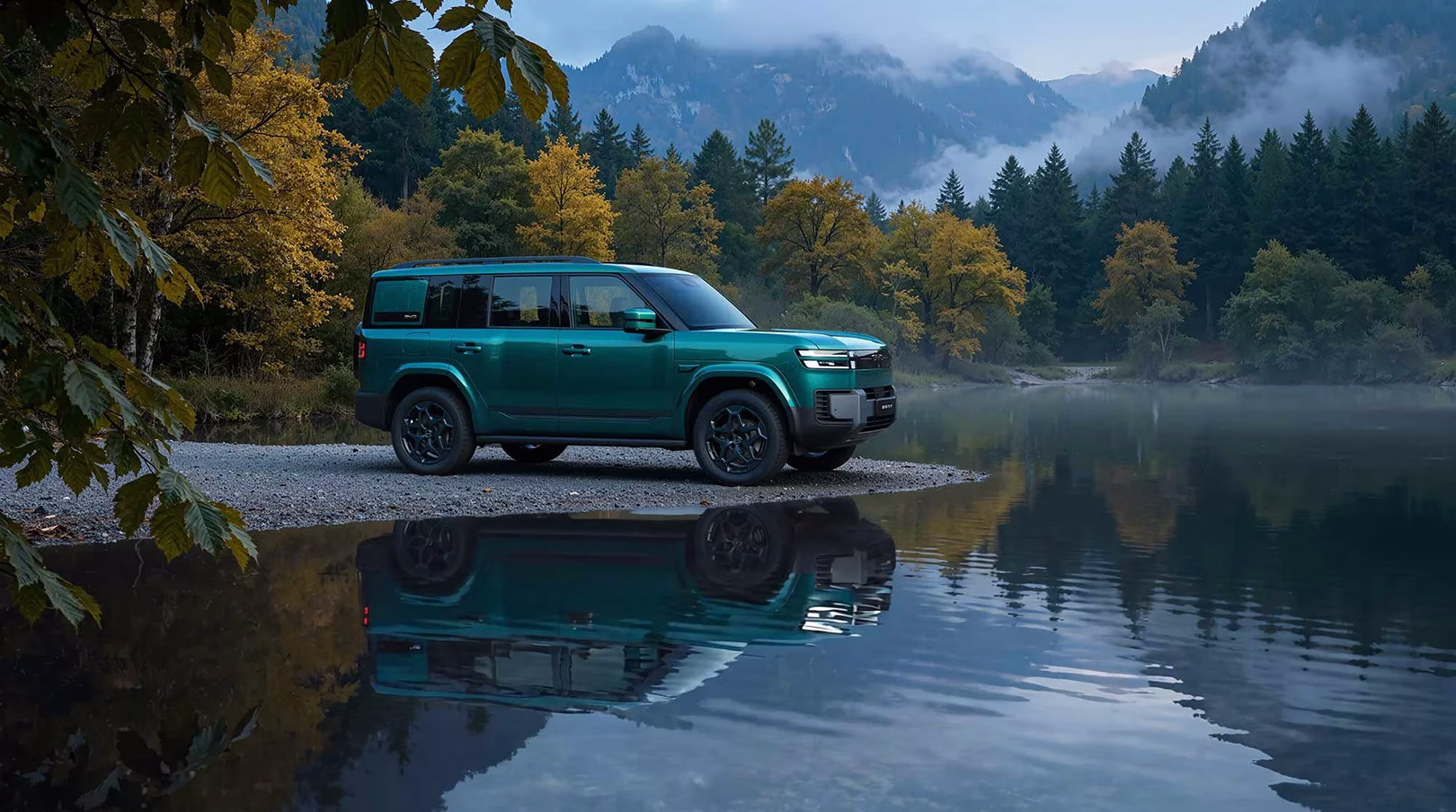 Green BYD Ti7 parked beside a mountain lake with its reflection in the water