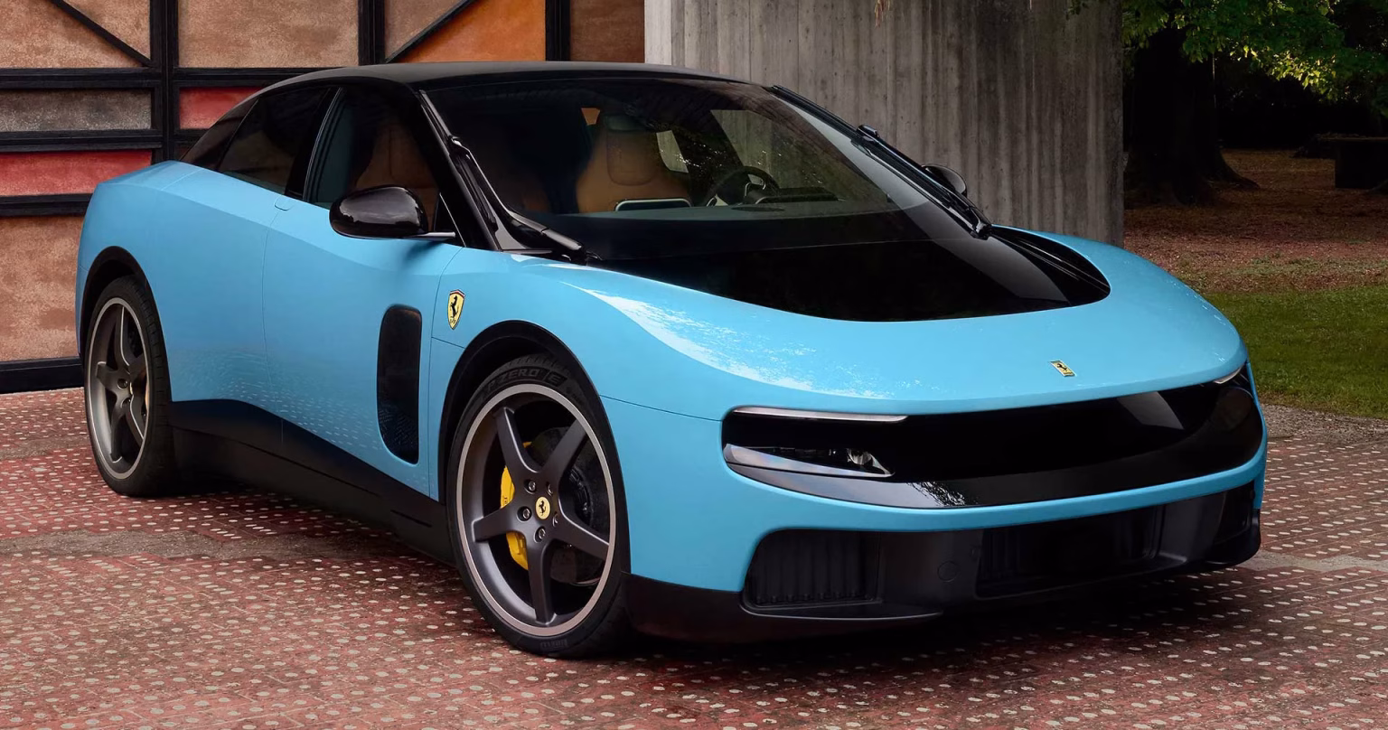Pale blue Ferrari Luce electric car front three quarter view on a brick driveway