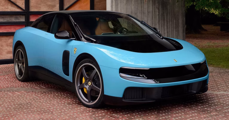 Pale blue Ferrari Luce electric car front three quarter view on a brick driveway